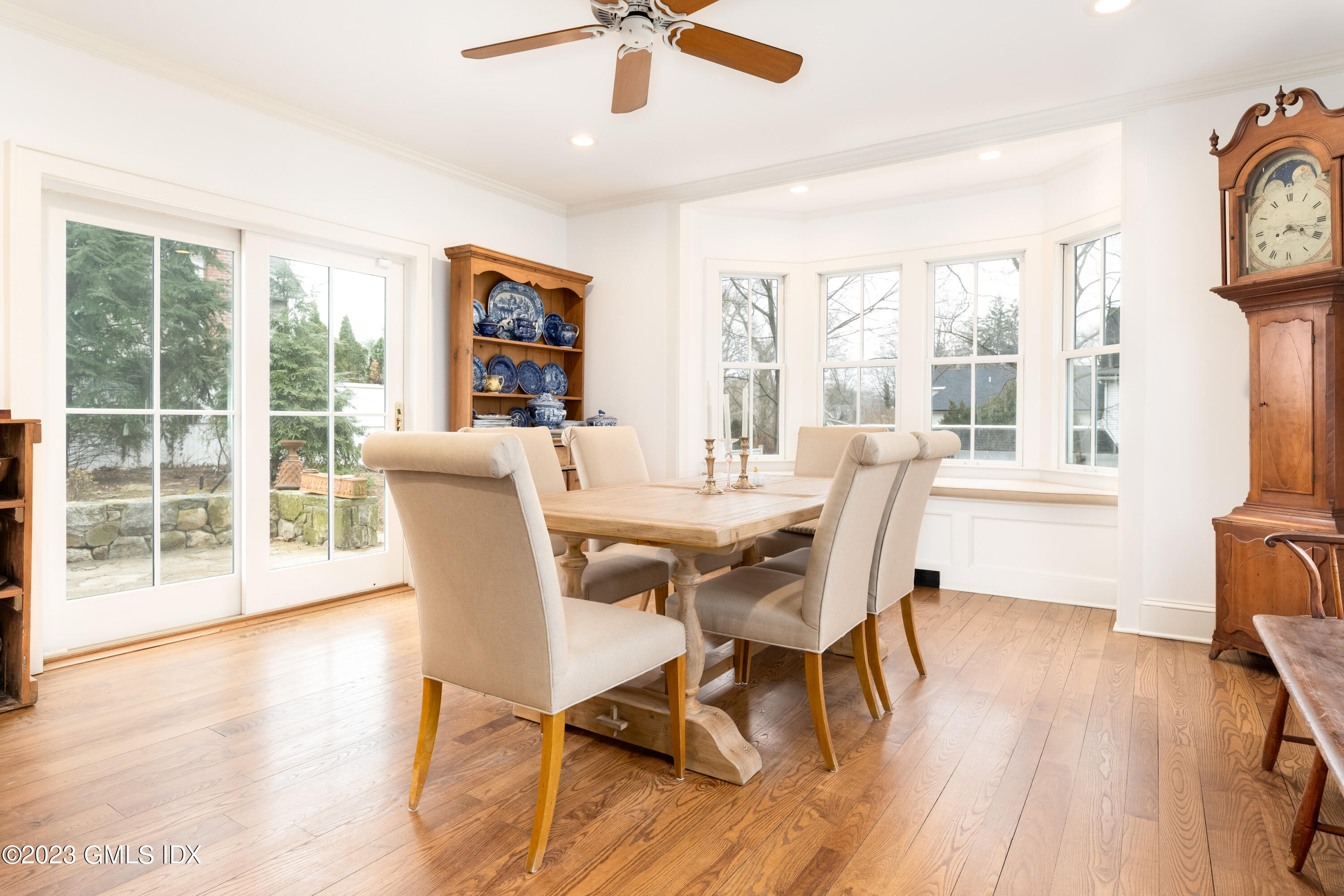 93 Riverside Avenue Riverside, CT 06878 - Photo 10 of 19 a dining room with wooden floor a chandelier a glass table and chairs