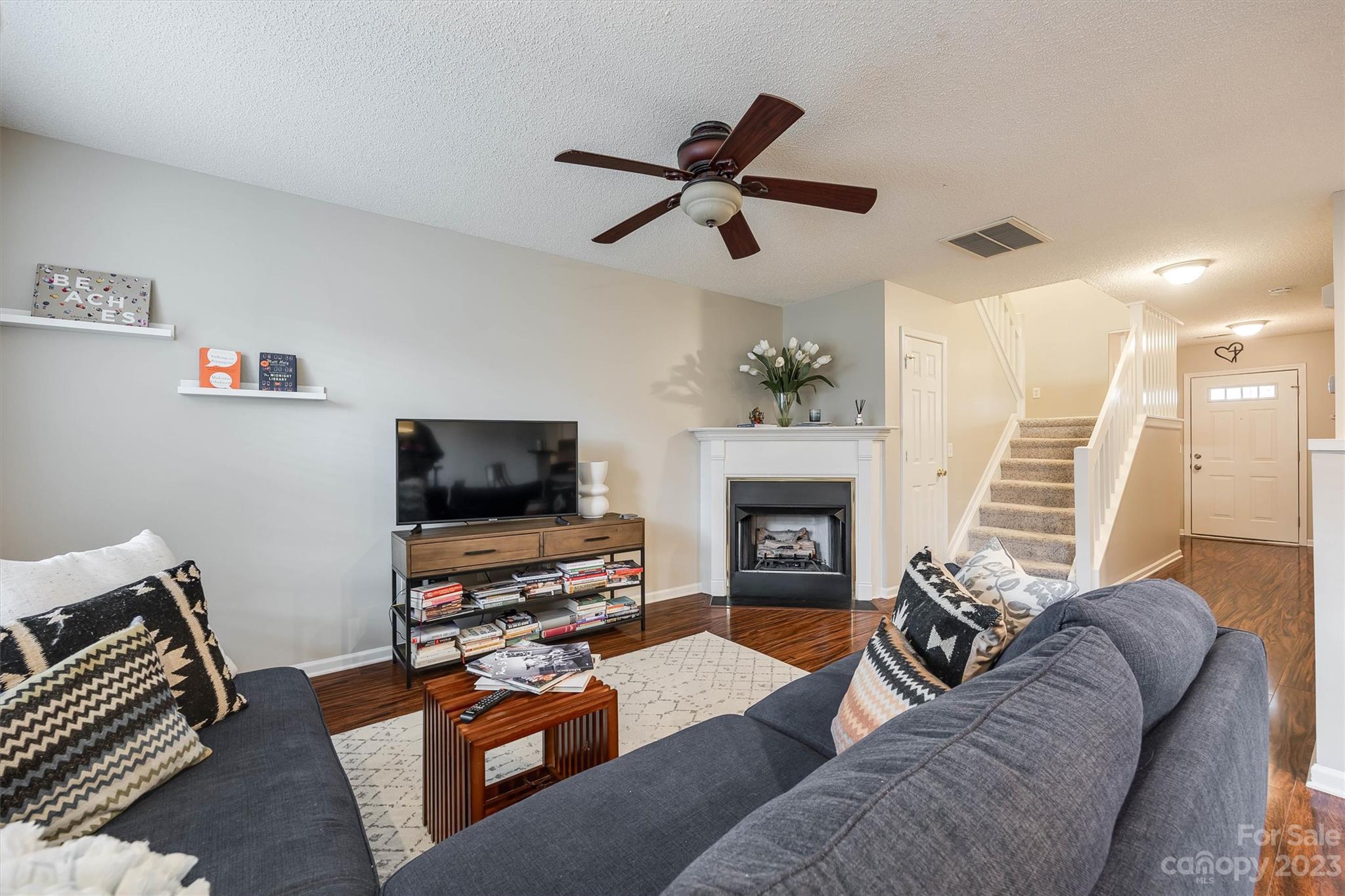 9725 Mattforest Circle Charlotte, NC 28277 - Photo 11 of 29 a living room with furniture a fireplace and a flat screen tv
