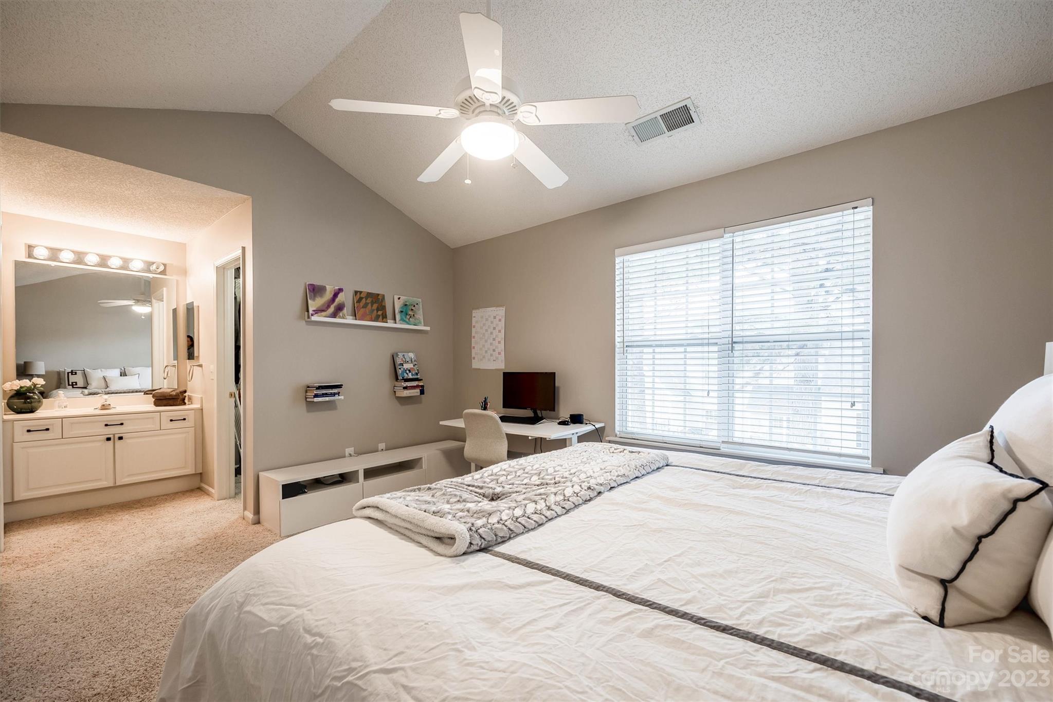 9725 Mattforest Circle Charlotte, NC 28277 - Photo 24 of 29 a spacious bedroom with a large bed and a large window