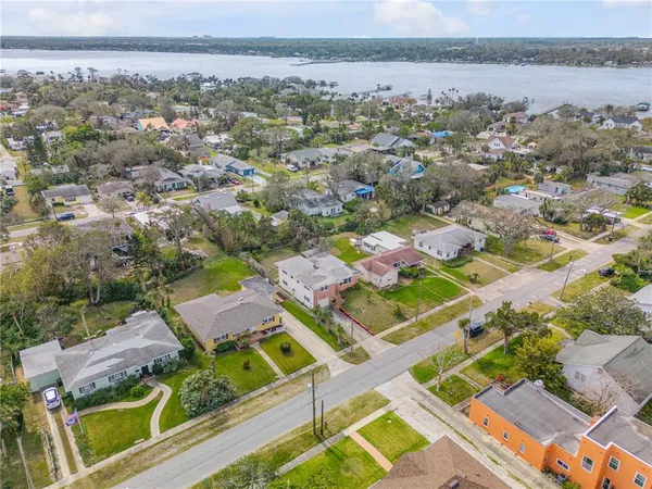 an aerial view of a city with lots of residential buildings and mountain view in back
