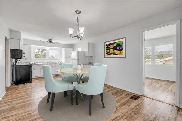 a view of a dining room with furniture wooden floor and chandelier