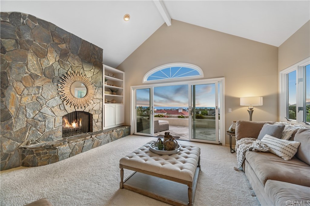 5 Marbella San Clemente, CA 92673 - Photo 3 of 49 a living room with furniture a fireplace and a floor to ceiling window
