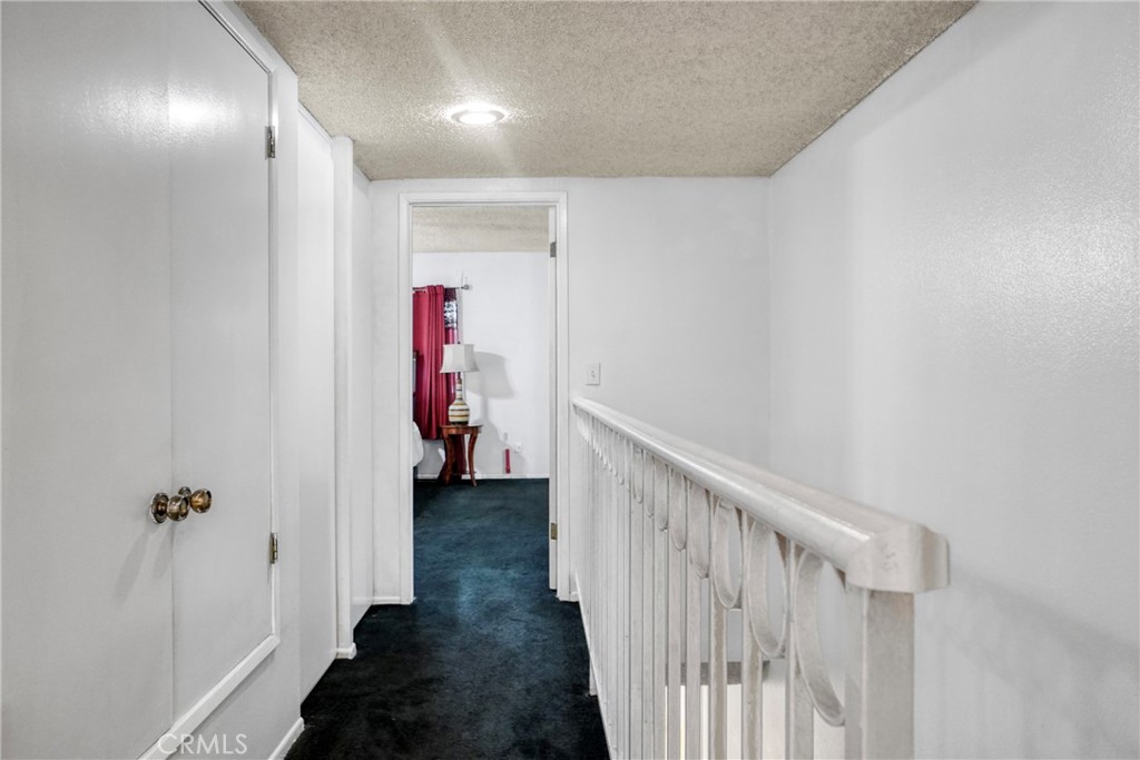 21602 South Figueroa Street, Unit 10 Carson, CA 90745 - Photo 12 of 25 a view of a hallway with wooden floor and stairs