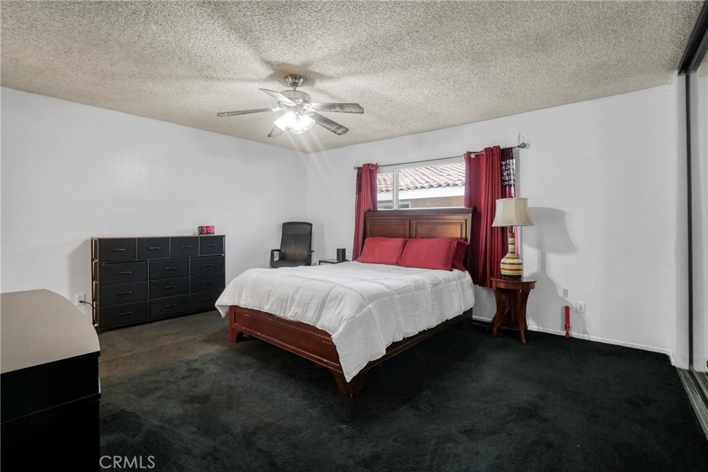 21602 South Figueroa Street, Unit 10 Carson, CA 90745 - Photo 13 of 25 a bedroom with a bed and a chandelier