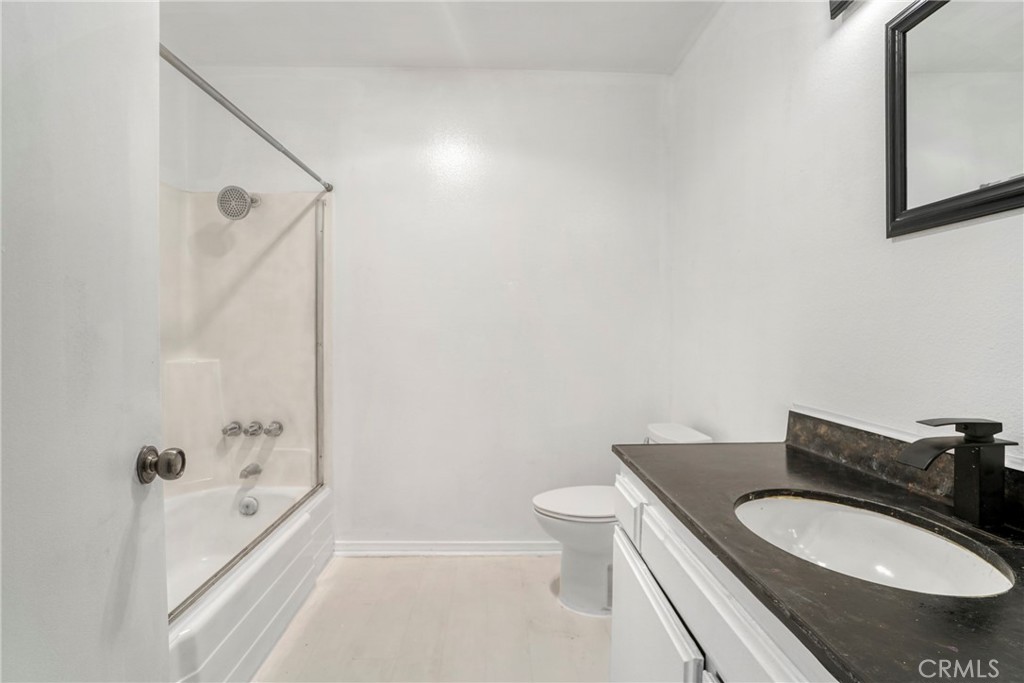 21602 South Figueroa Street, Unit 10 Carson, CA 90745 - Photo 15 of 25 a bathroom with a granite countertop sink a toilet and bathtub