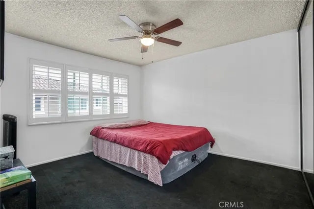a bed sitting in a bedroom next to a window