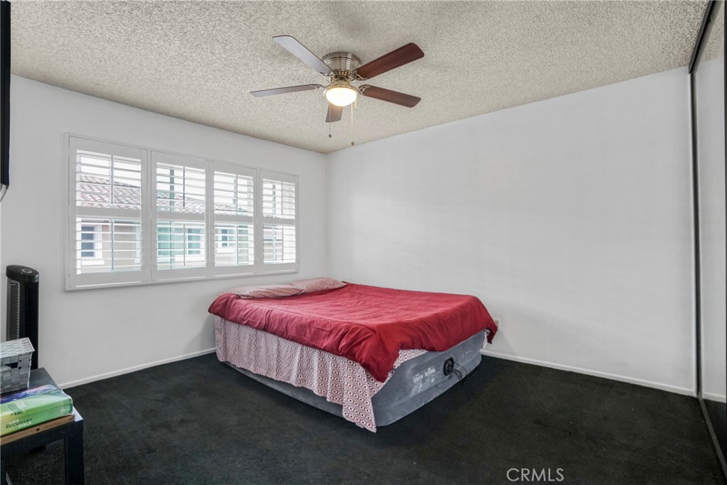 21602 South Figueroa Street, Unit 10 Carson, CA 90745 - Photo 17 of 25 a bed sitting in a bedroom next to a window