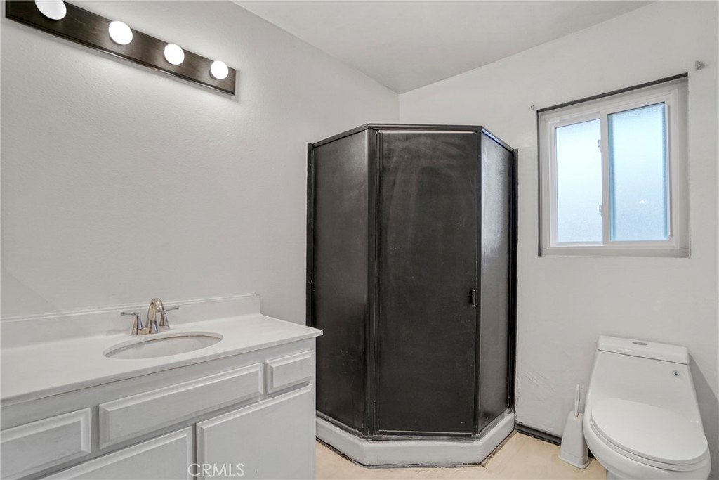 21602 South Figueroa Street, Unit 10 Carson, CA 90745 - Photo 18 of 25 a bathroom with a sink a toilet and mirror