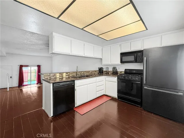 a kitchen with granite countertop stainless steel appliances and wooden cabinets