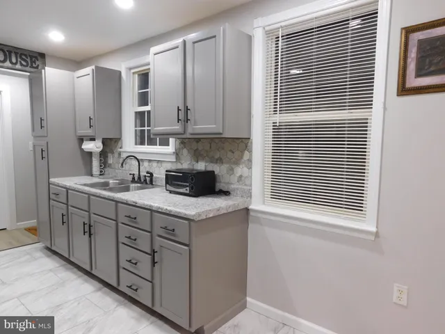 a white toilet sitting next to a window