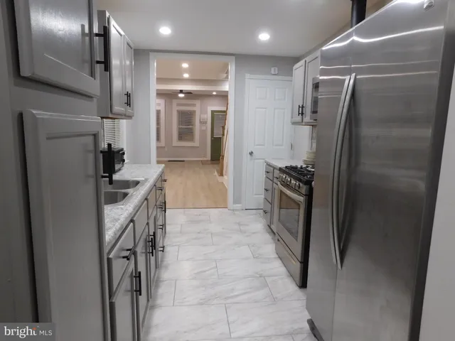 a view of a blue building with a bench in front of it