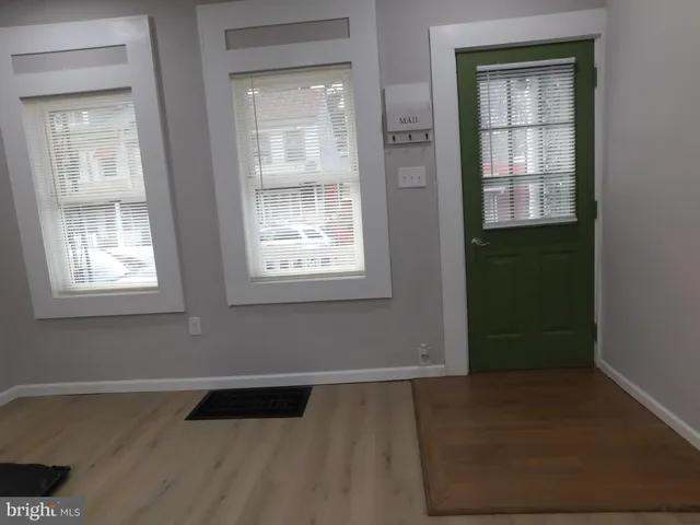 an empty room with windows and closet
