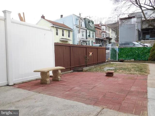 a view of a small space with wooden floor and a window