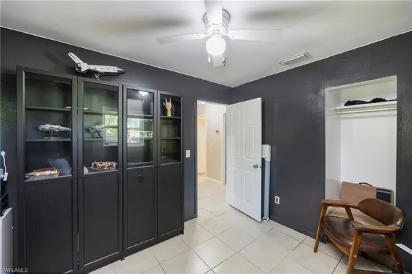a room with stainless steel appliances kitchen island granite countertop furniture and a refrigerator