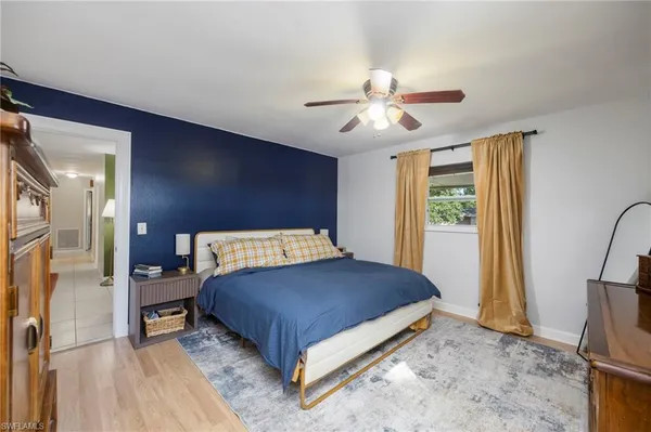a bedroom with a bed dresser and a large mirror