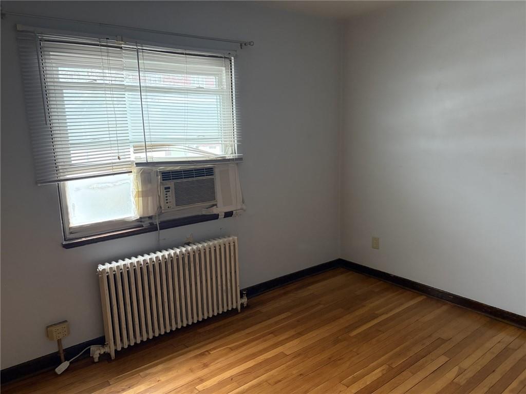 5839 Darlington Road, Unit 1 Pittsburgh, PA 15217 - Photo 11 of 18 an empty room with wooden floor and windows