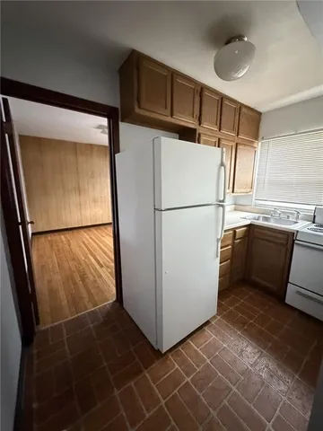 a white refrigerator freezer and a dishwasher in a kitchen