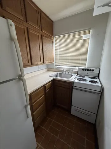 a utility room with sink dryer and washer