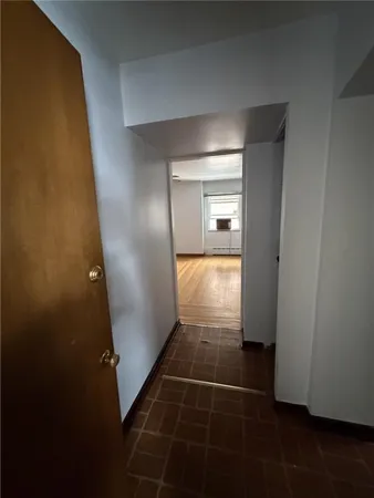 an empty room with wooden floor and door