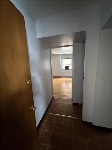 an empty room with wooden floor and door