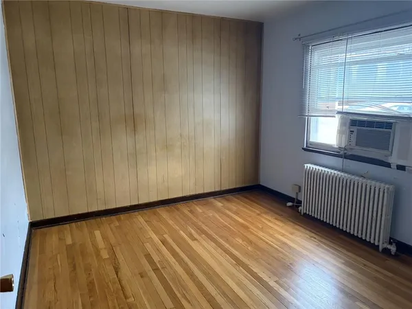 a view of a room with wooden floor and windows