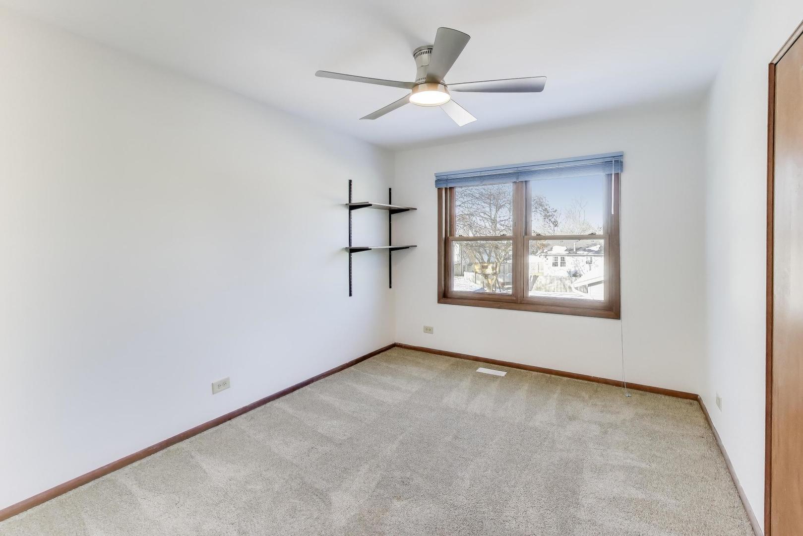 549 Ridgewood Lane Buffalo Grove, IL 60089 - Photo 14 of 17 an empty room with windows and ceiling fan