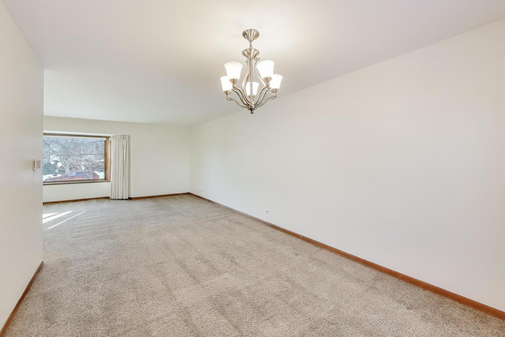549 Ridgewood Lane Buffalo Grove, IL 60089 - Photo 5 of 17 a view of an empty room with a window