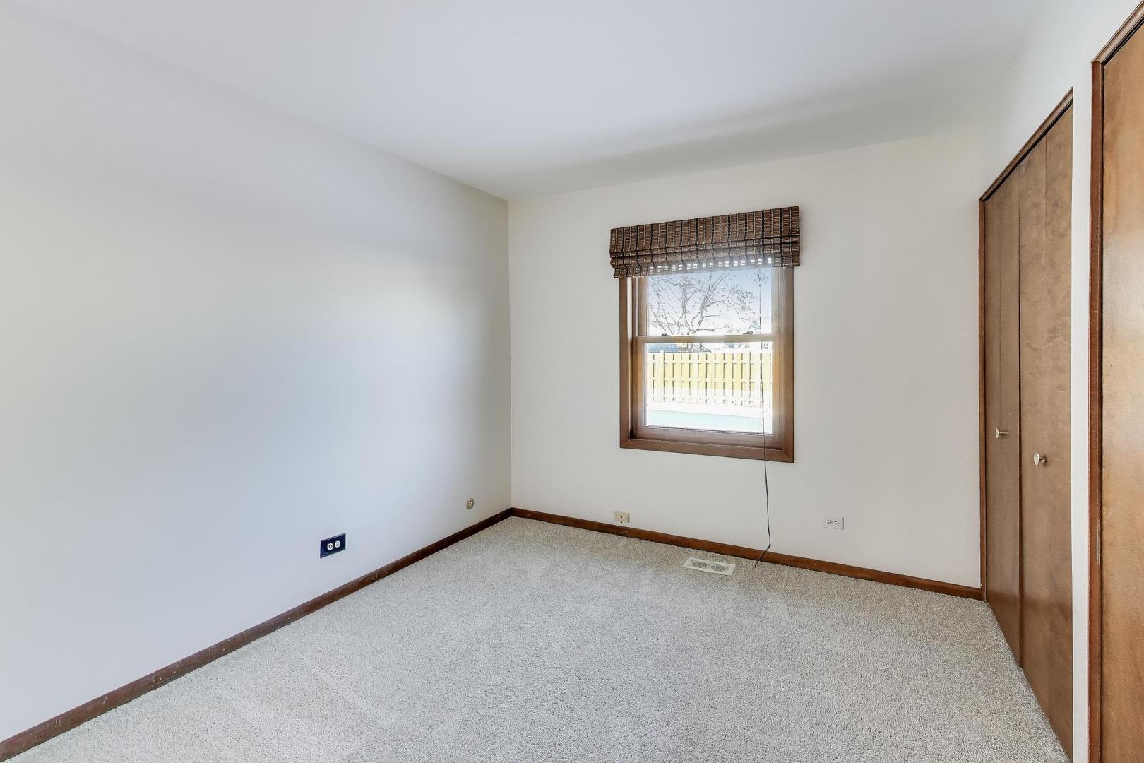 549 Ridgewood Lane Buffalo Grove, IL 60089 - Photo 9 of 17 a view of an empty room with a window