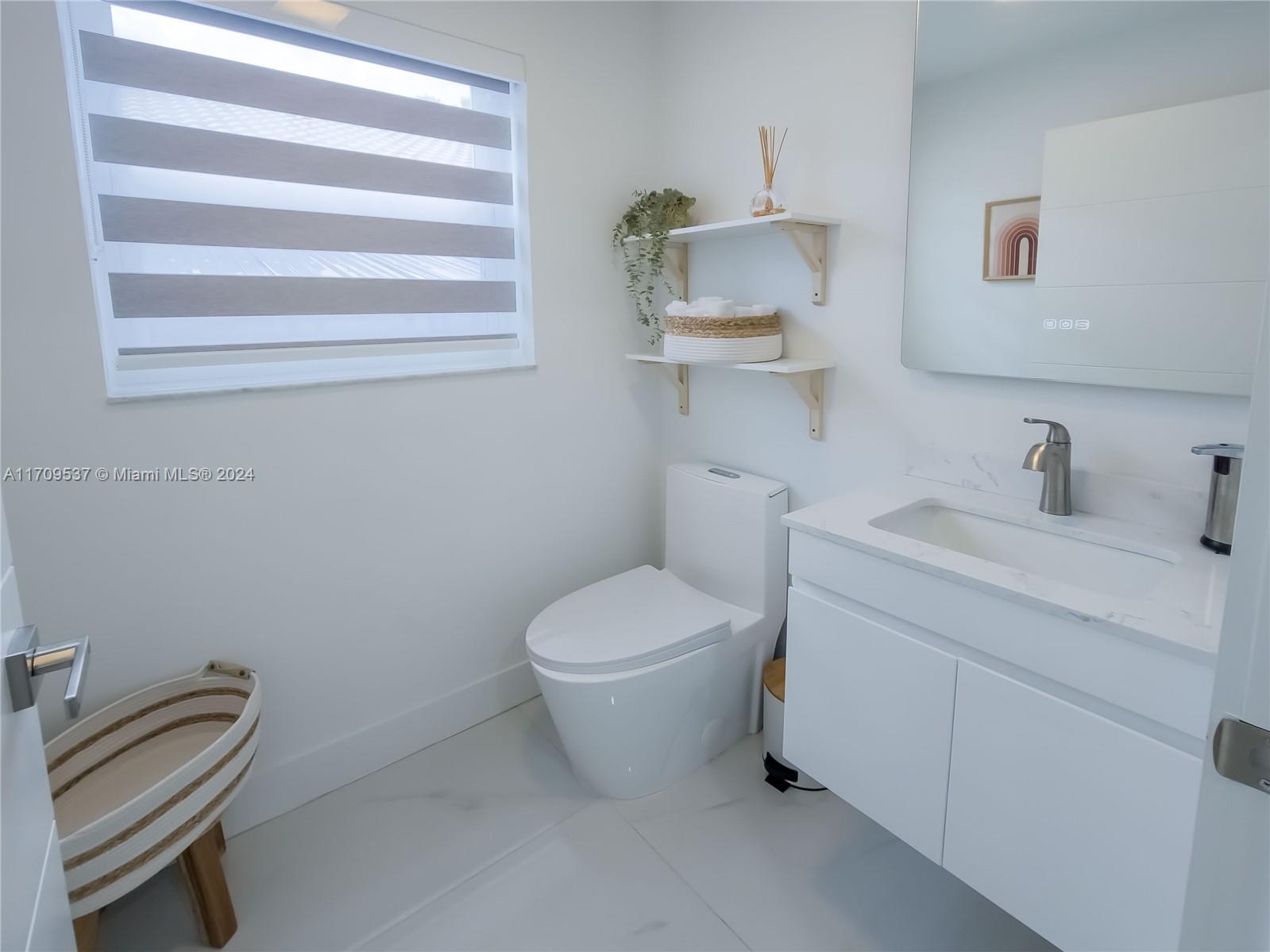 18199 Southwest 3rd Street Pembroke Pines, FL 33029 - Photo 11 of 31 a bathroom with a sink a toilet and vanity