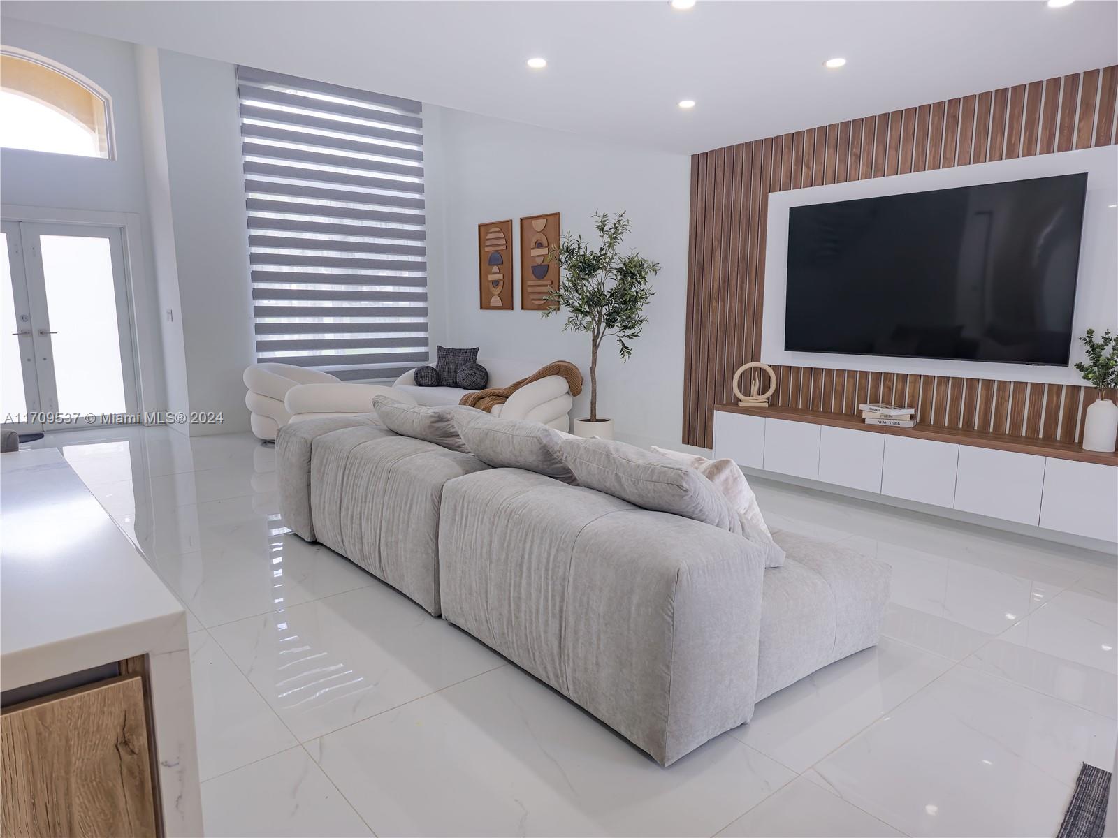 18199 Southwest 3rd Street Pembroke Pines, FL 33029 - Photo 13 of 31 a living room with furniture and a flat screen tv
