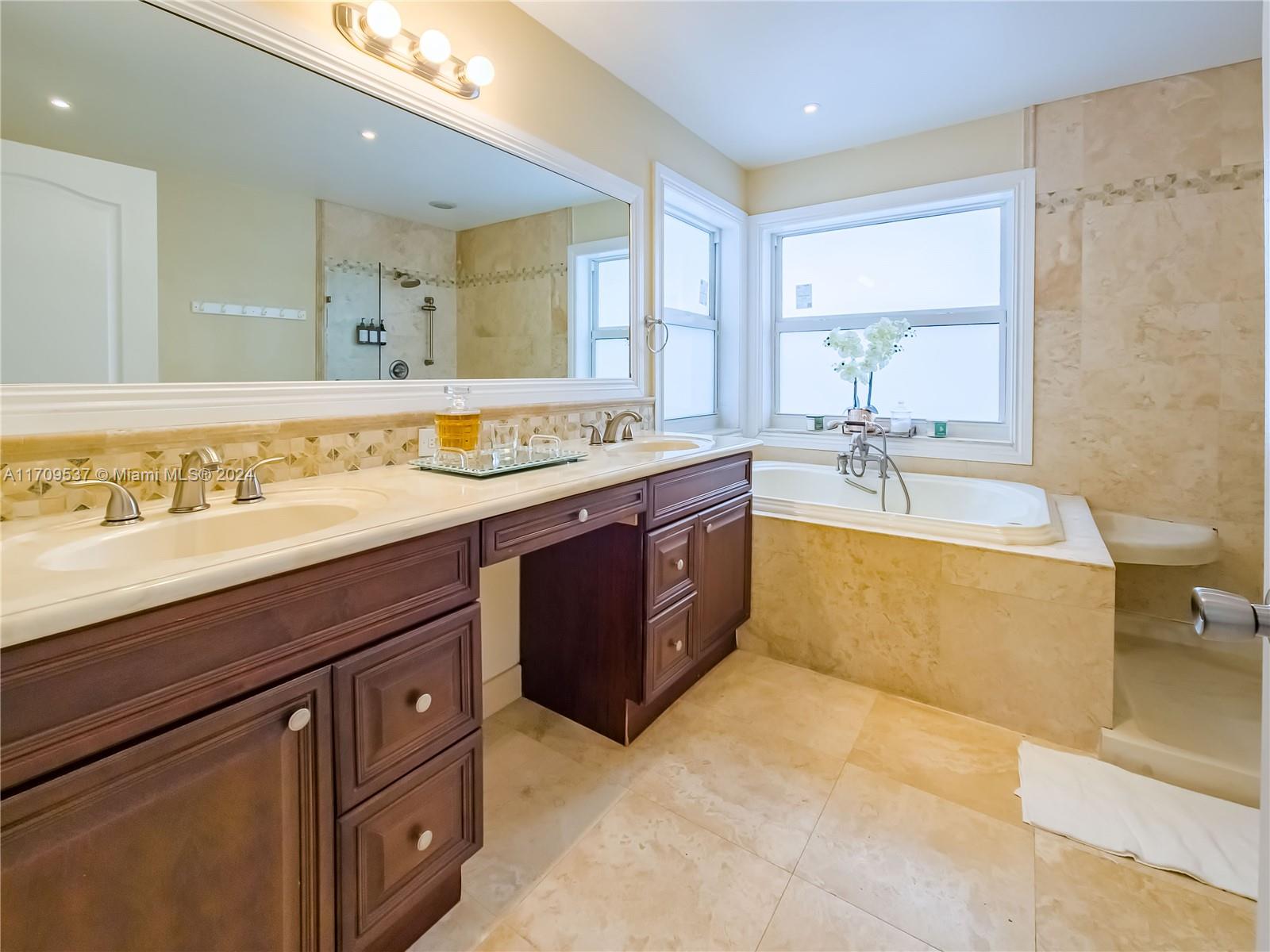 18199 Southwest 3rd Street Pembroke Pines, FL 33029 - Photo 21 of 31 a spacious bathroom with a tub double sink and mirror
