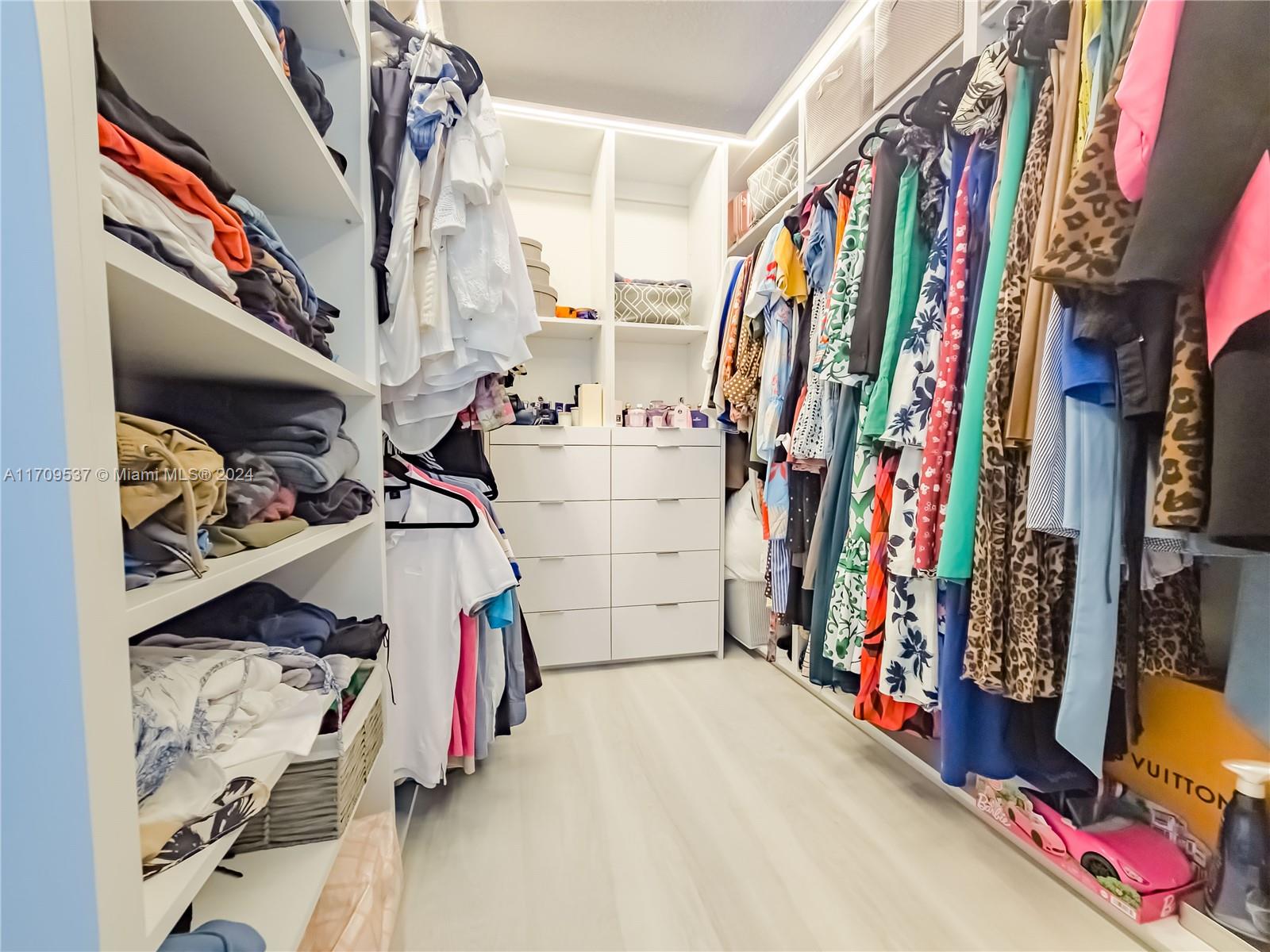 18199 Southwest 3rd Street Pembroke Pines, FL 33029 - Photo 23 of 31 a view of walk in closet with clothes and shoes