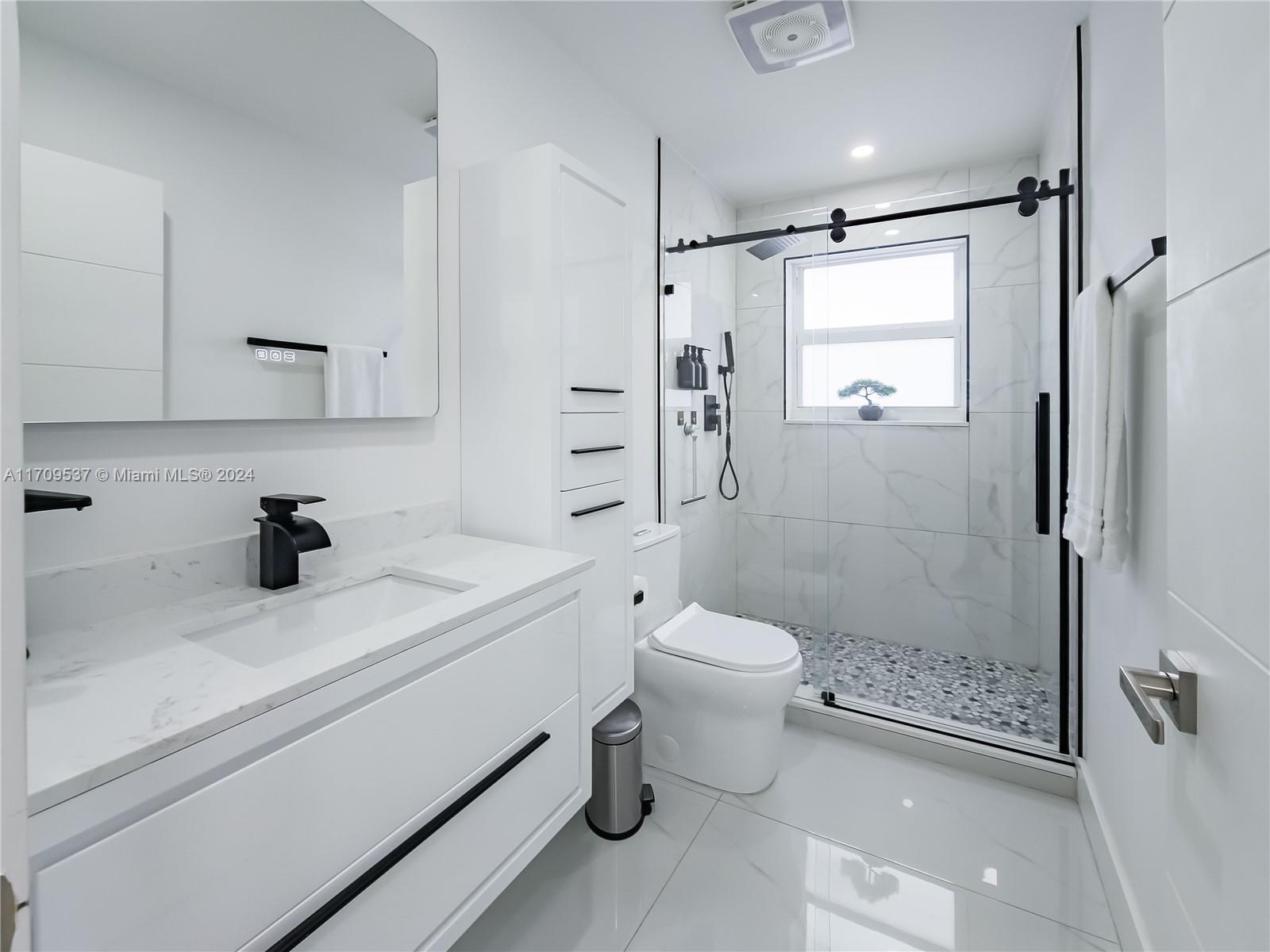 18199 Southwest 3rd Street Pembroke Pines, FL 33029 - Photo 26 of 31 a bathroom with a sink a toilet and shower