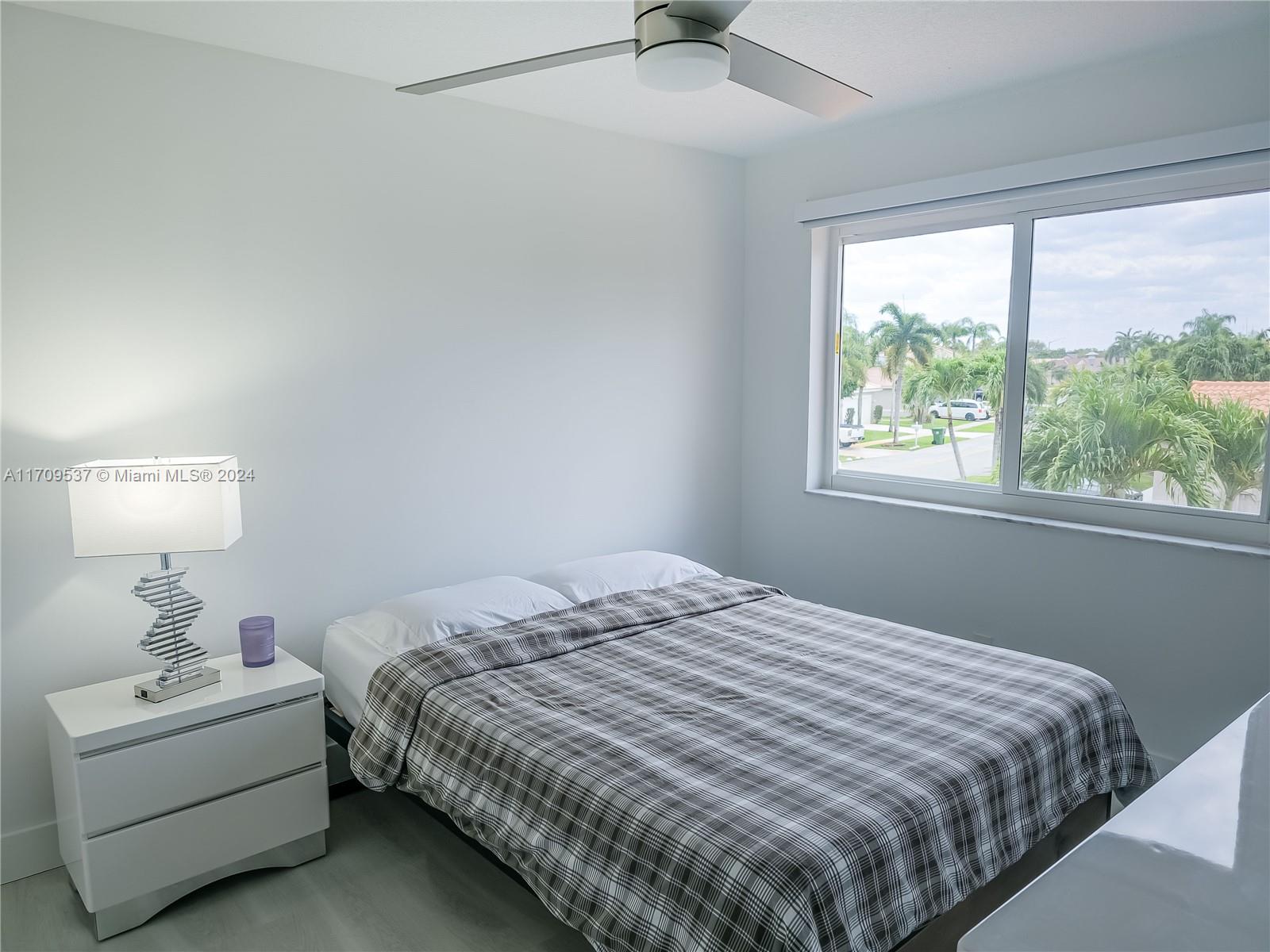 18199 Southwest 3rd Street Pembroke Pines, FL 33029 - Photo 27 of 31 a bedroom with a bed and a window