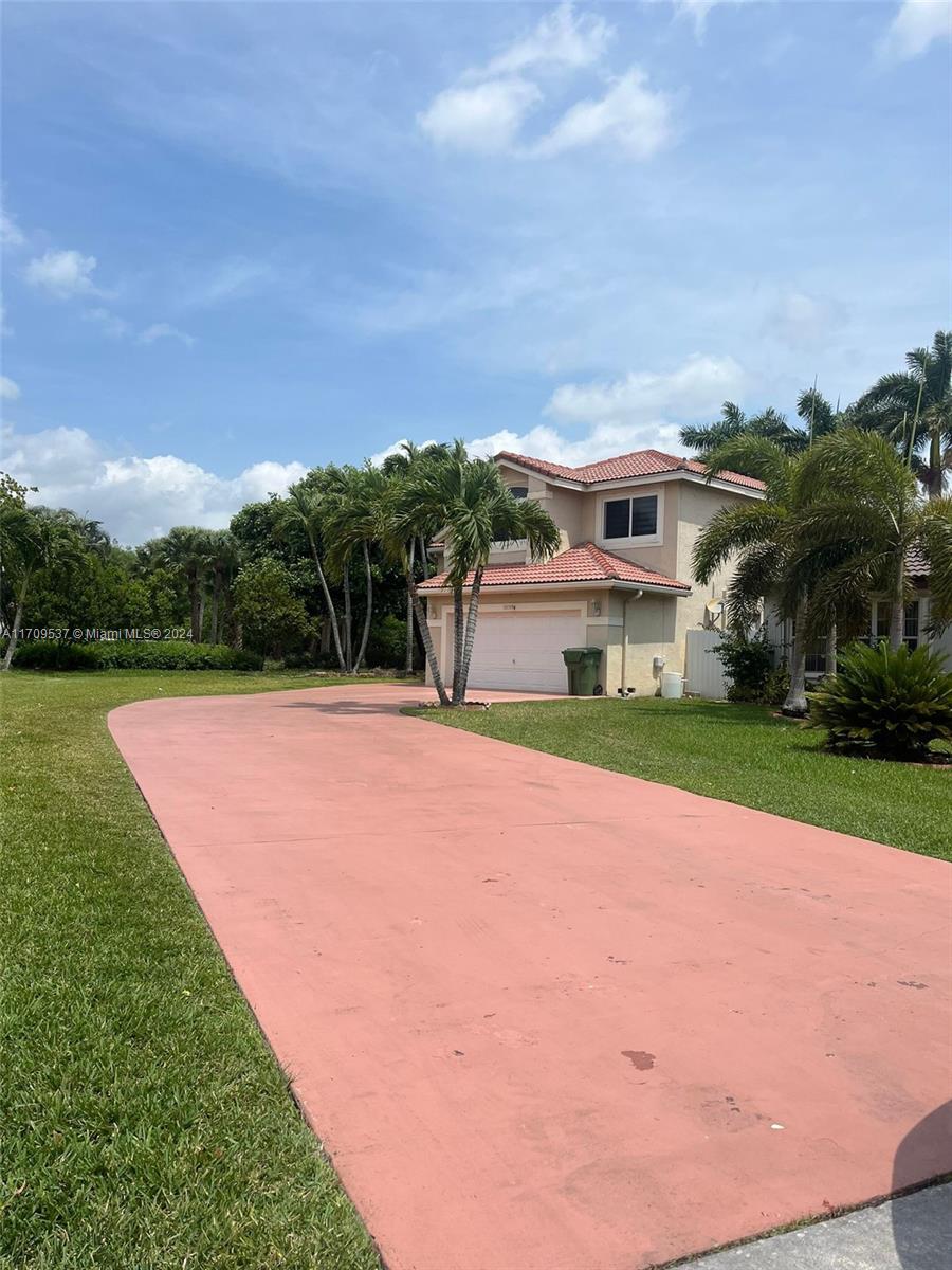 18199 Southwest 3rd Street Pembroke Pines, FL 33029 - Photo 31 of 31 a front view of house with yard and green space