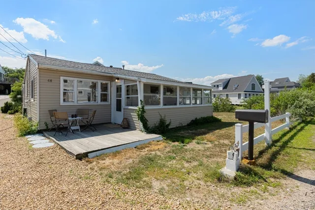 a view of a house with backyard and sitting area