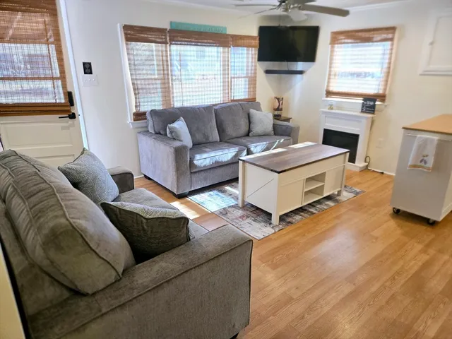 a living room with furniture fireplace and a flat screen tv