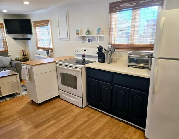 a kitchen with a sink stove and microwave