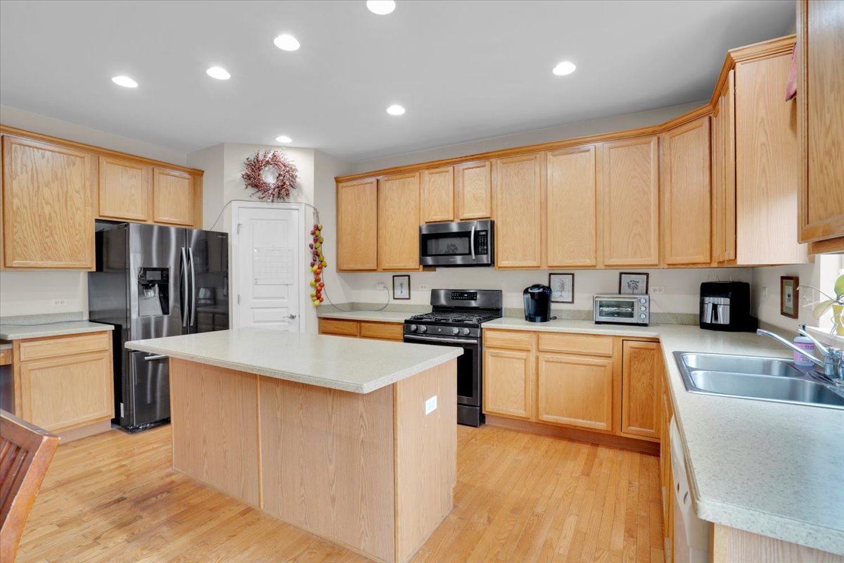 7 Springbrook Court Streamwood, IL 60107 - Photo 13 of 36 a kitchen with stainless steel appliances granite countertop a refrigerator stove microwave sink and cabinets