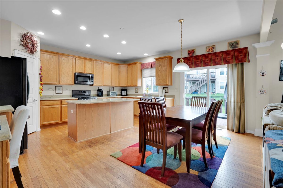 7 Springbrook Court Streamwood, IL 60107 - Photo 14 of 36 a kitchen with kitchen island wooden cabinets and stainless steel appliances