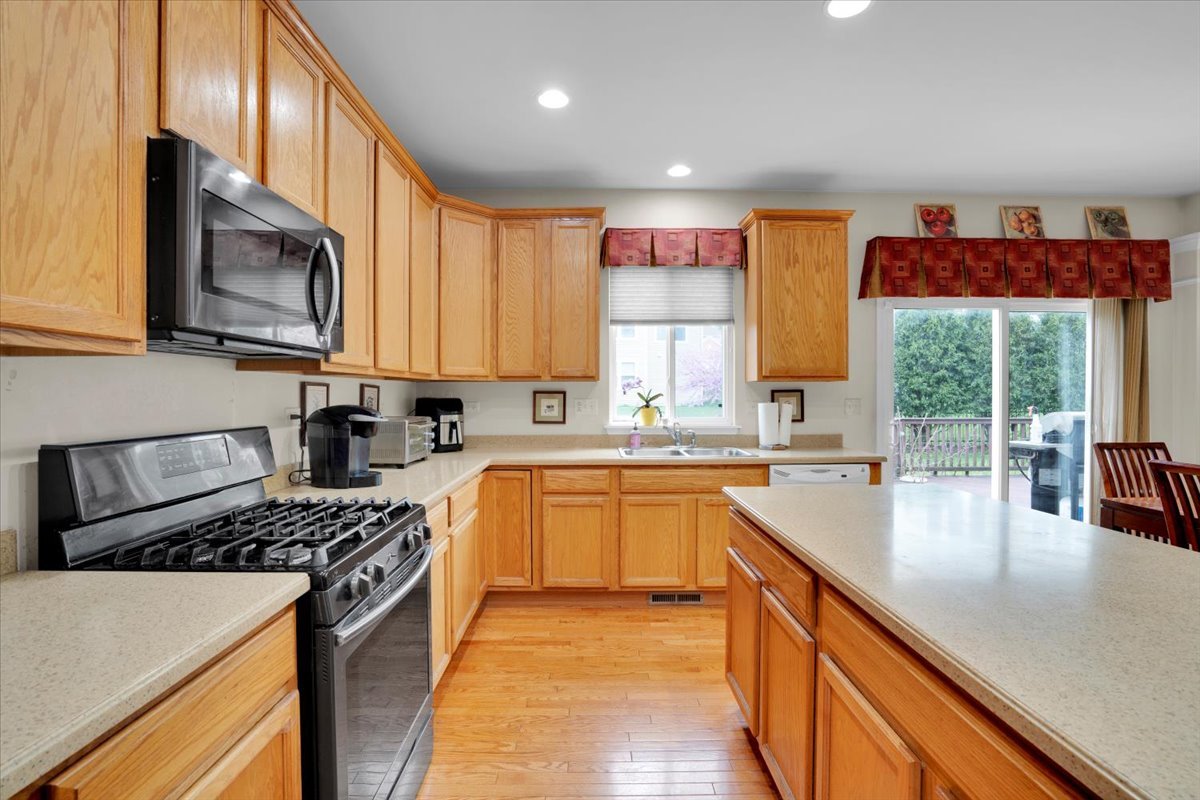 7 Springbrook Court Streamwood, IL 60107 - Photo 15 of 36 a kitchen with stainless steel appliances granite countertop a stove a sink and a microwave