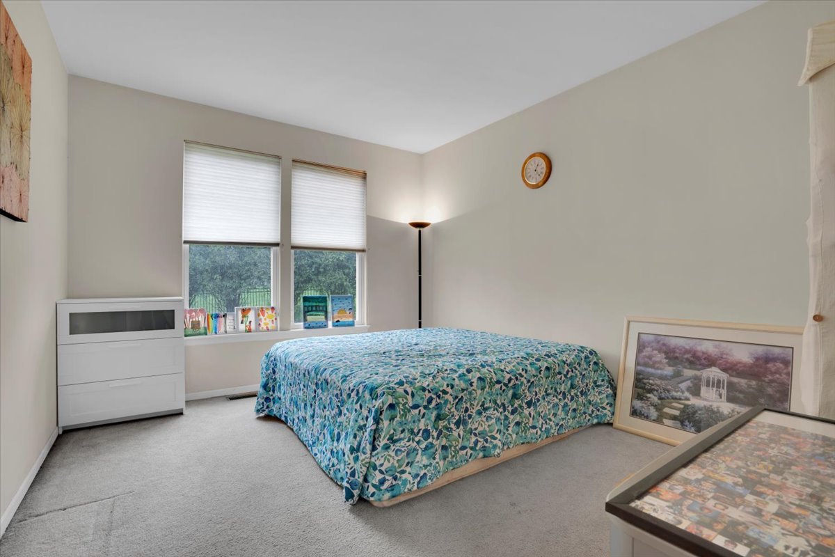 7 Springbrook Court Streamwood, IL 60107 - Photo 17 of 36 a room with a bed and a window