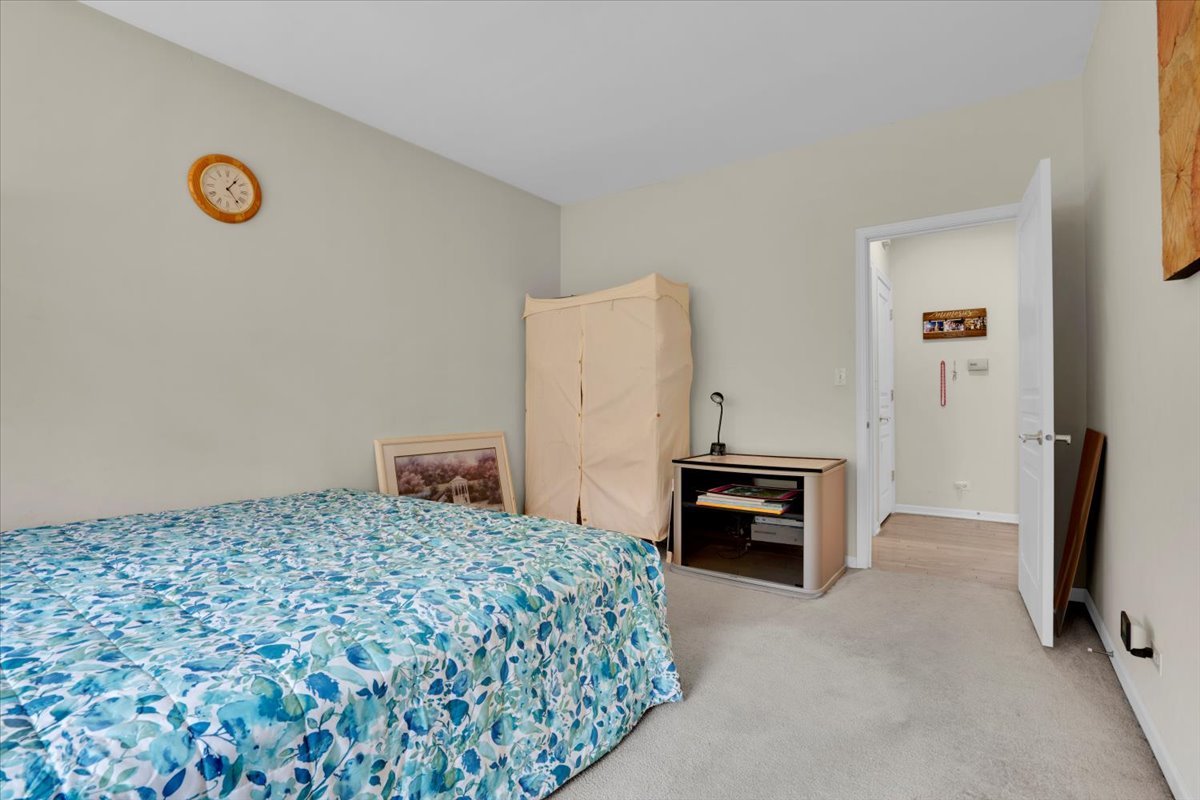 7 Springbrook Court Streamwood, IL 60107 - Photo 18 of 36 a bedroom with a bed and a table