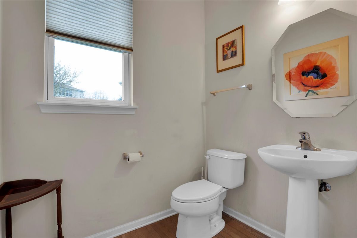 7 Springbrook Court Streamwood, IL 60107 - Photo 19 of 36 a bathroom with a toilet a sink and mirror