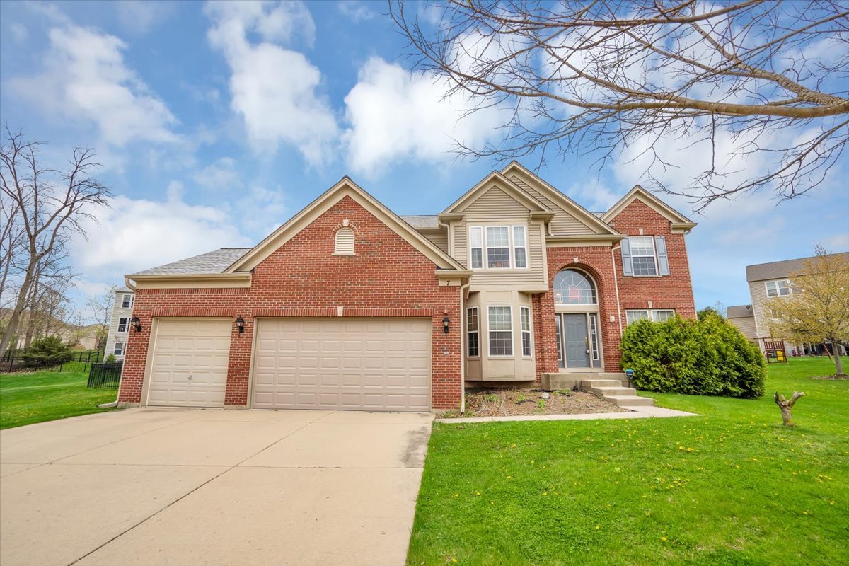7 Springbrook Court Streamwood, IL 60107 - Photo 2 of 36 a front view of a house with a yard and garage