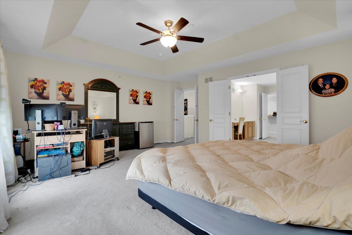 7 Springbrook Court Streamwood, IL 60107 - Photo 21 of 36 a spacious bedroom with a bed and a chandelier