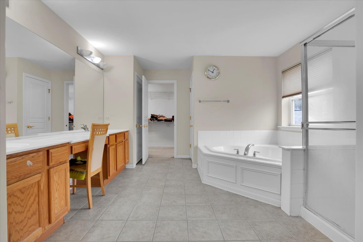 7 Springbrook Court Streamwood, IL 60107 - Photo 22 of 36 a spacious bathroom with a tub sink and mirror