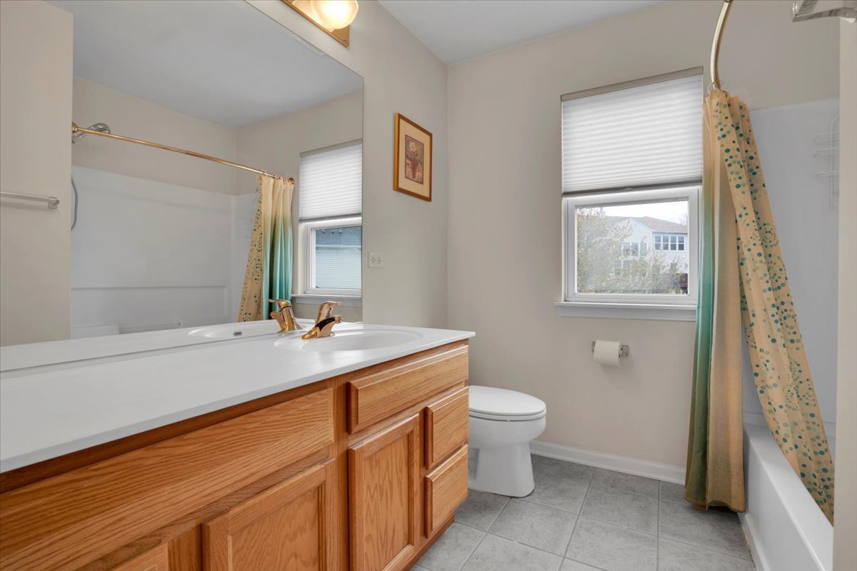 7 Springbrook Court Streamwood, IL 60107 - Photo 27 of 36 a bathroom with a sink toilet and window