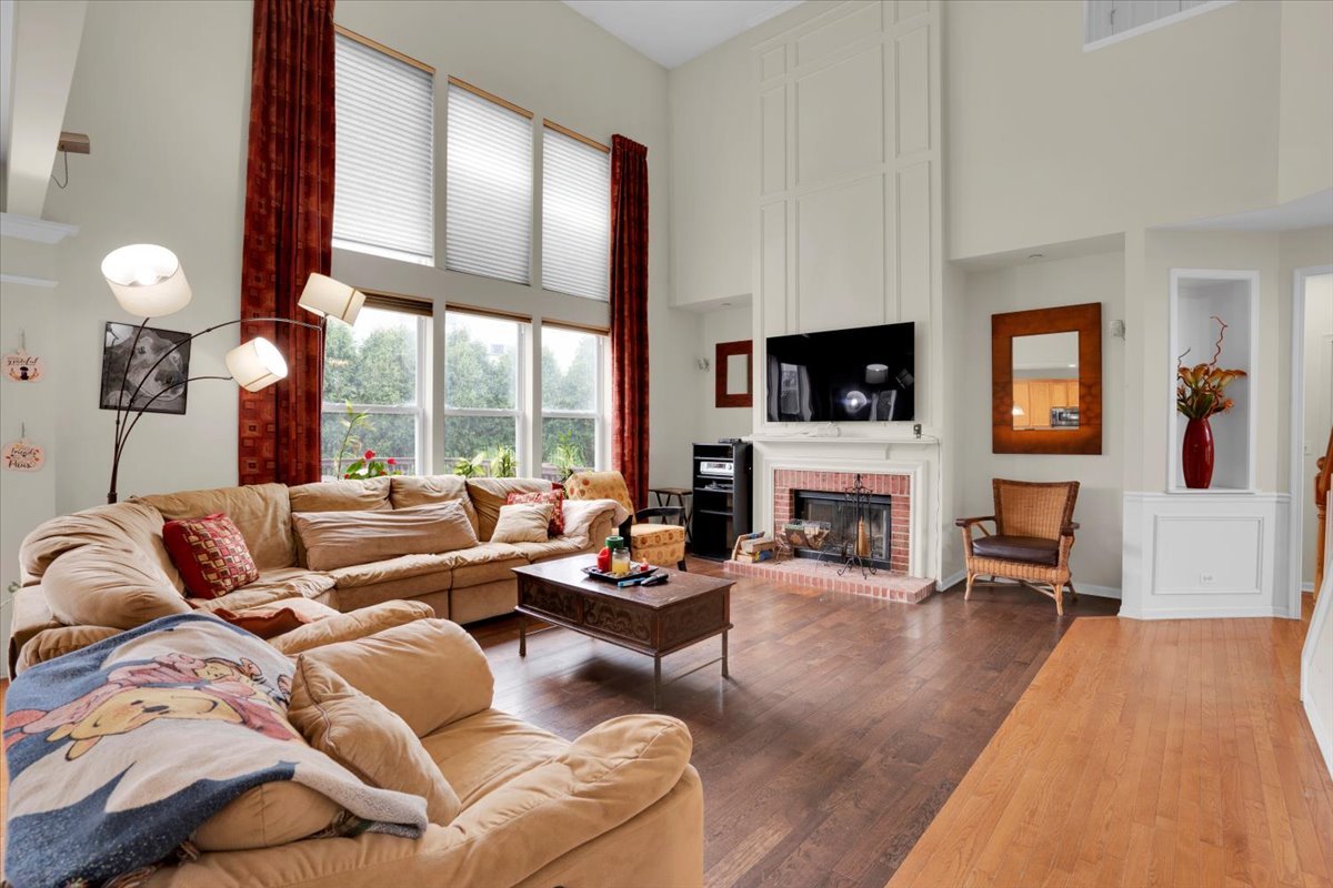 7 Springbrook Court Streamwood, IL 60107 - Photo 9 of 36 a living room with fireplace furniture and a large window