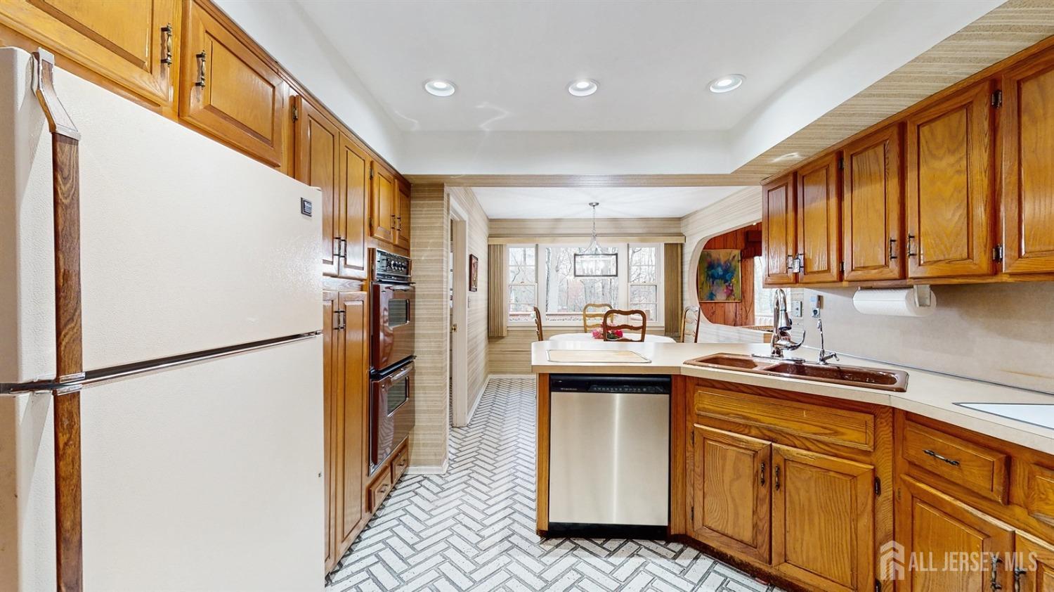 4 Whitewood Road Edison, NJ 08820 - Photo 11 of 31 a kitchen with refrigerator and window